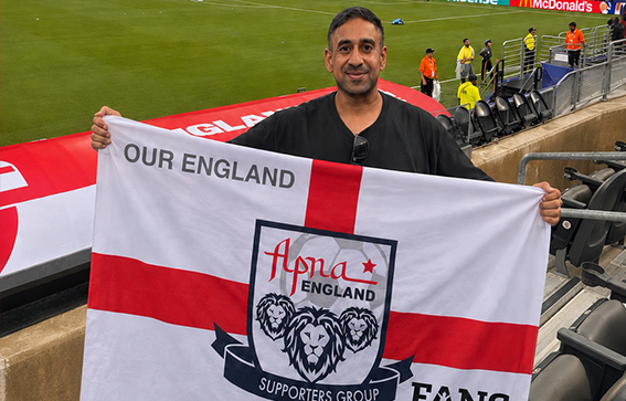 Sash holding Apna England Flag